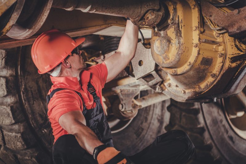 Heavy diesel mechanic working on machinery